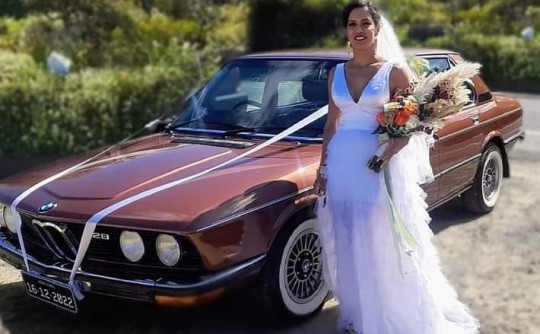 The beautiful bride with the beautiful bridal car